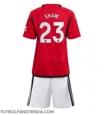 Manchester United Luke Shaw #23 Primera Equipación Niños 2023-24 Manga Corta (+ Pantalones cortos)